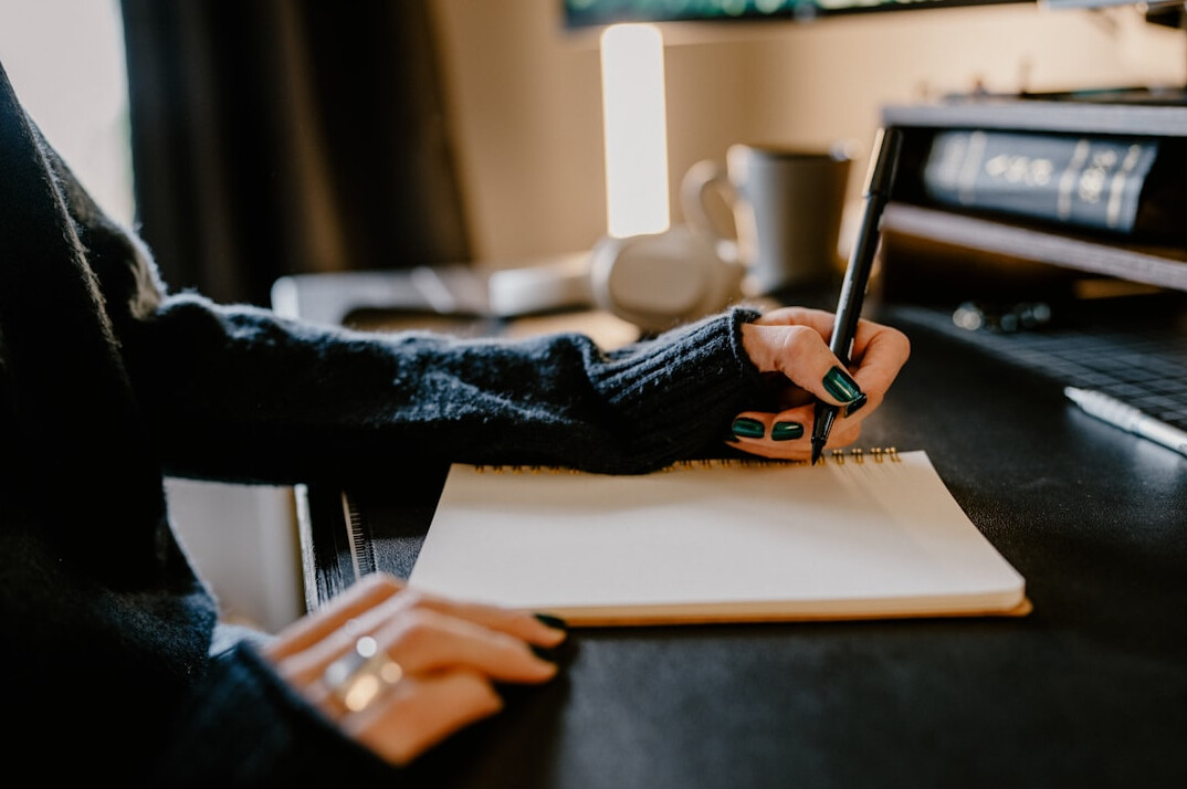 mystery writer at desk with notebook