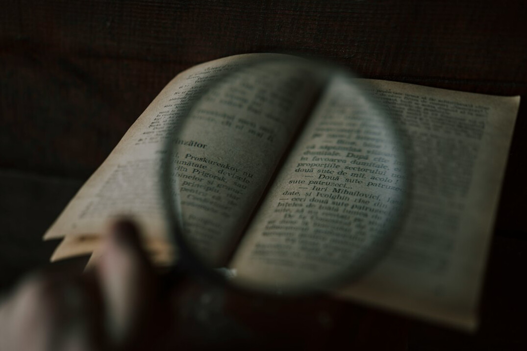 open book with magnifying glass